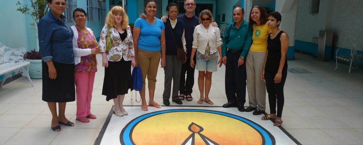 Equipe de Coordenação da Pastoral do Cego no Sodalício da Sacra Família da Tijuca. No piso, o logotipo da Instituição.