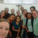 São 12 pessoas intérpretes de LIBRAS das Comunidades de Surdos do Rio e do Regional Leste 1. Estão todos em pé par uma self. Local: Mitra Arquidiocesana na Glória.